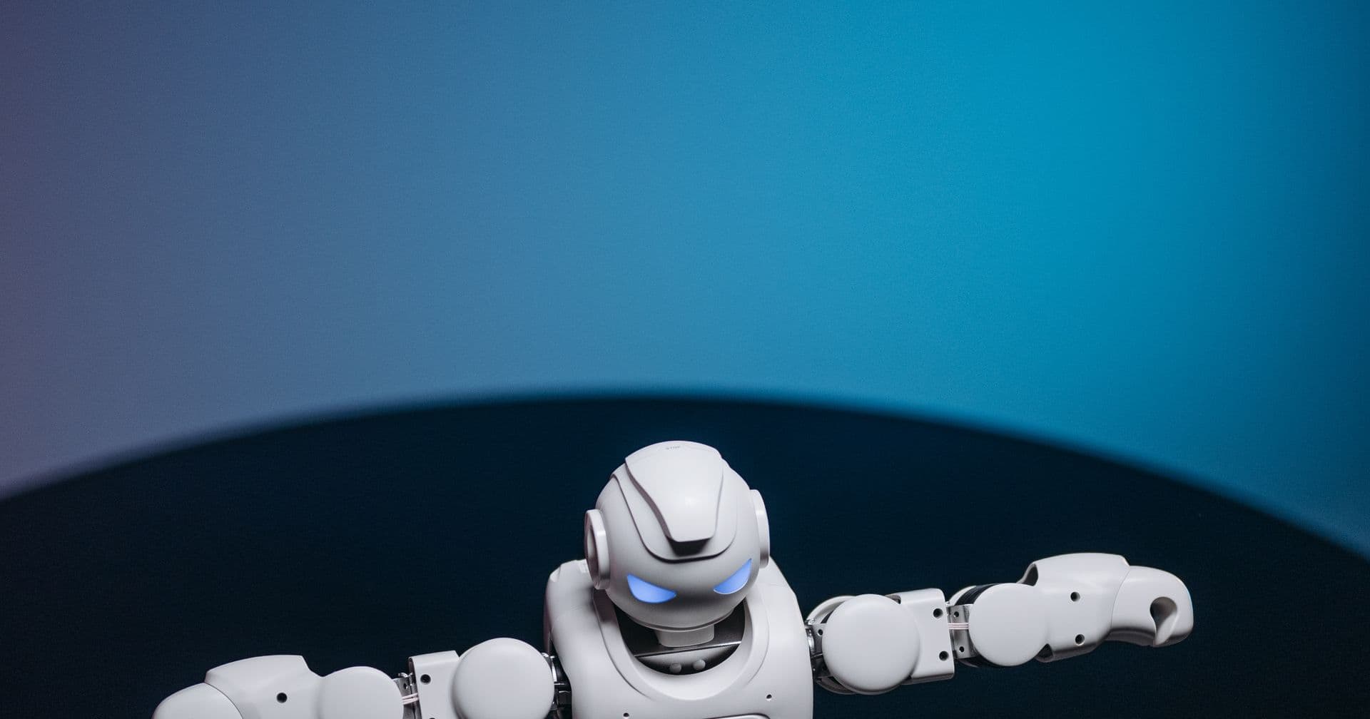 A white robot with glowing eyes and outstretched arms, evoking robots.txt crawl control