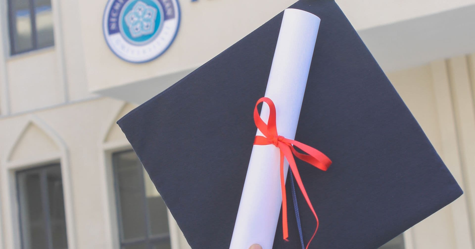 A wall of framed credentials beside a graduation cap — like E-E-A-T experience, expertise, authority and trust