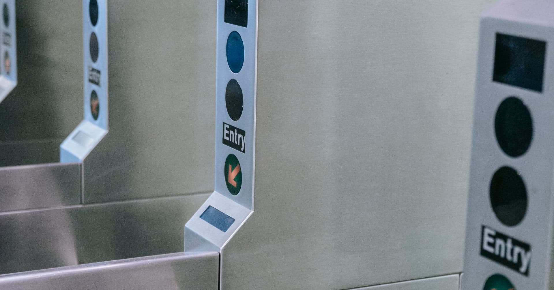 A subway turnstile gate controlling who passes through — like a robots.txt file controlling which crawlers may access a site