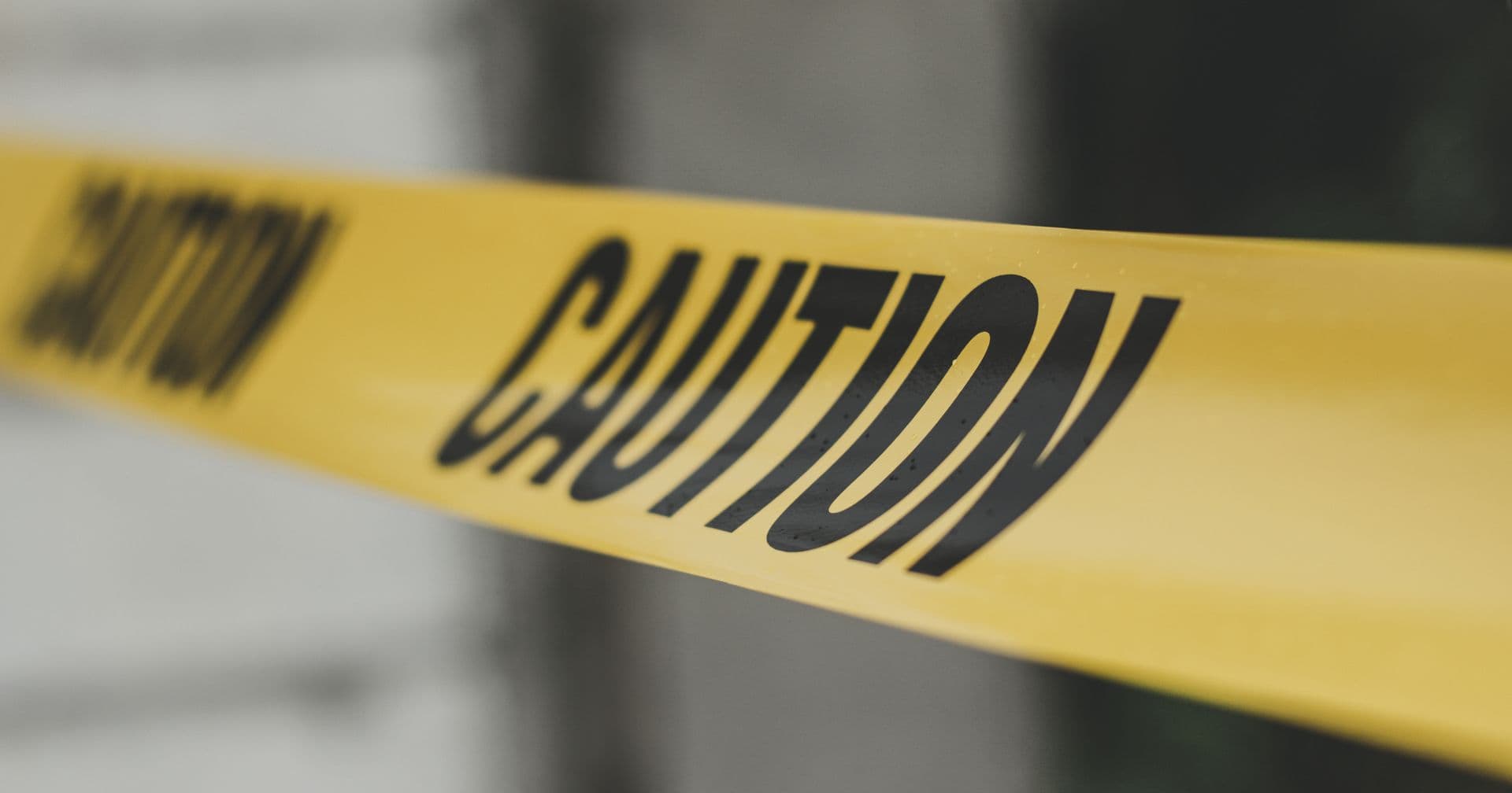 Yellow caution tape stretched across a scene — like a high spam score flagging risky links and signals