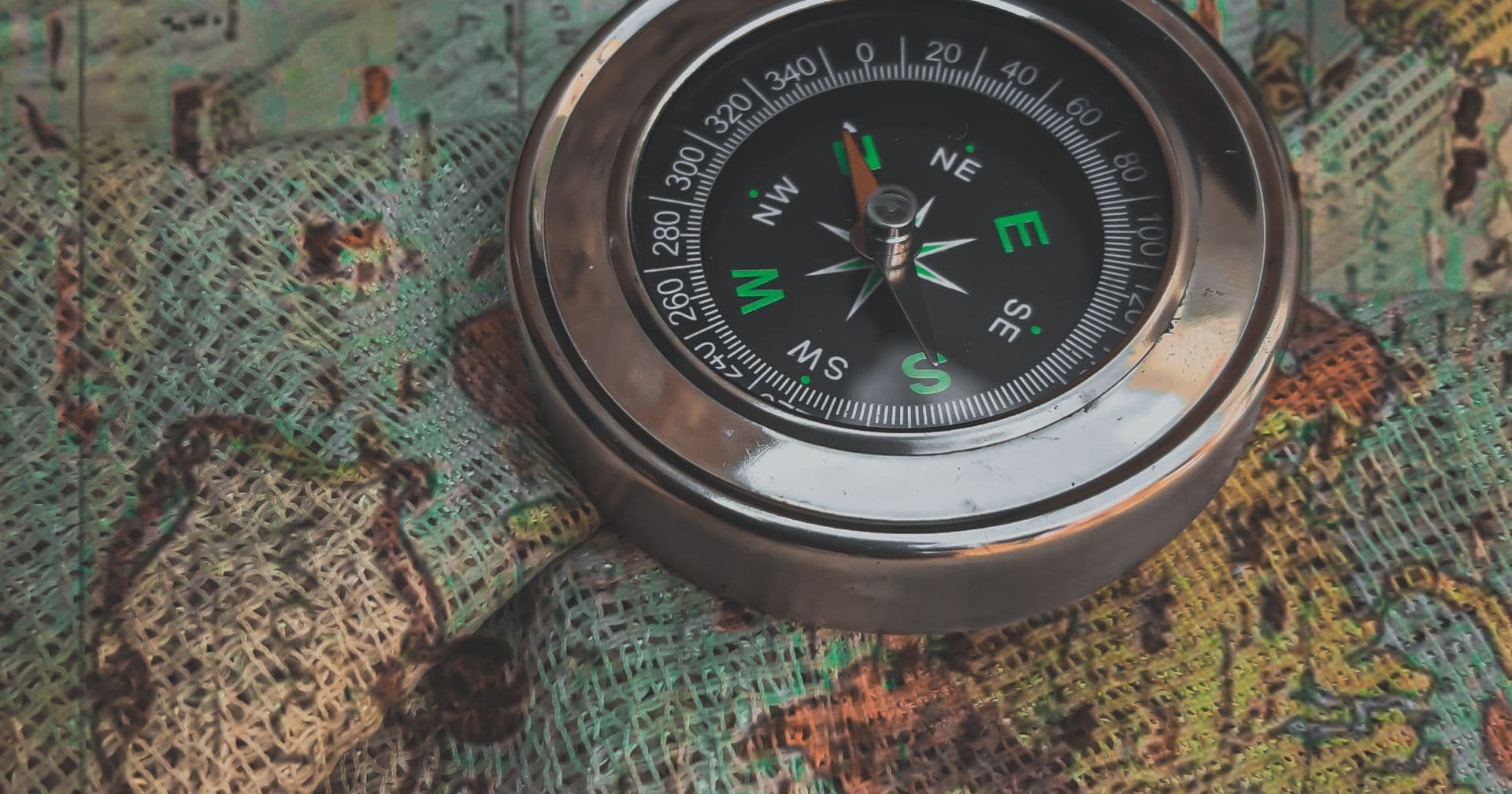 A vintage compass resting on an antique world map, evoking an XML sitemap